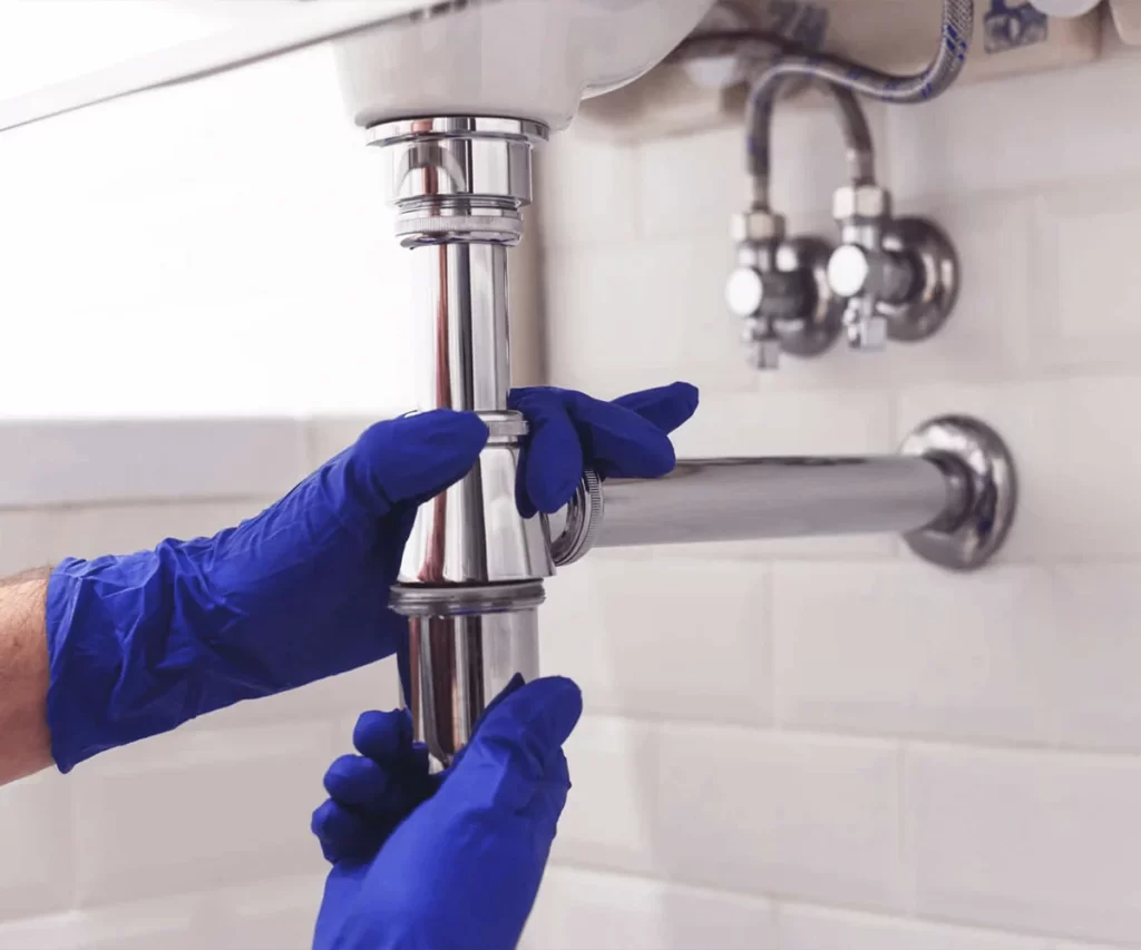 Plumber repairing pipe fittings in Dubai
